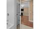 Bathroom with bathtub/shower and doorway into a living room with fireplace at 3209 Telhurst Way, Buford, GA 30519