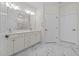 Bright bathroom features a double sink vanity with white cabinets and marble countertops at 3209 Telhurst Way, Buford, GA 30519