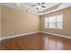 Bedroom featuring hardwood floors, neutral walls, and a window letting in lots of light at 3209 Telhurst Way, Buford, GA 30519