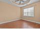 Cozy bedroom with hardwood floors, tray ceiling, and a bright window at 3209 Telhurst Way, Buford, GA 30519