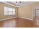 Well lit bedroom featuring hardwood floors, neutral walls, and views of the exterior at 3209 Telhurst Way, Buford, GA 30519