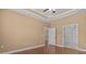 Spacious bedroom with hardwood floors, neutral walls, and access to the ensuite bathroom at 3209 Telhurst Way, Buford, GA 30519