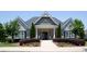 Community clubhouse entrance with manicured landscaping and patriotic decor at 3209 Telhurst Way, Buford, GA 30519