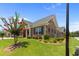 Beautifully landscaped brick home featuring a well-manicured lawn, brick facade, and flowering trees at 3209 Telhurst Way, Buford, GA 30519
