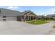Beautiful brick home with attached garage, well-maintained lawn, and colorful flowering trees at 3209 Telhurst Way, Buford, GA 30519