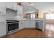 Bright kitchen with white cabinets, stainless steel appliances, and hardwood floors at 3209 Telhurst Way, Buford, GA 30519