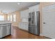 Well-lit kitchen featuring a stainless steel refrigerator and white cabinets at 3209 Telhurst Way, Buford, GA 30519