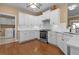 Kitchen with white cabinets, stainless appliances, and adjacent laundry room at 3209 Telhurst Way, Buford, GA 30519