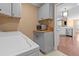 Well lit laundry room featuring stainless steel appliances and custom gray cabinets at 3209 Telhurst Way, Buford, GA 30519