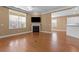 Living room featuring hardwood floors, fireplace, and large windows at 3209 Telhurst Way, Buford, GA 30519