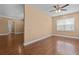 Spacious living room with gleaming hardwood floors and a ceiling fan at 3209 Telhurst Way, Buford, GA 30519
