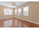 Open-plan living room with hardwood floors, lots of natural light, and ceiling fan at 3209 Telhurst Way, Buford, GA 30519