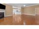 Open living area featuring hardwood floors, fireplace, and kitchen access at 3209 Telhurst Way, Buford, GA 30519