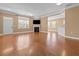 Open living area featuring fireplace, hardwood floors, and natural light at 3209 Telhurst Way, Buford, GA 30519