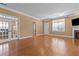 Spacious living room with fireplace, hardwood floors, and natural light at 3209 Telhurst Way, Buford, GA 30519