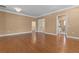 Open living space with hardwood flooring leading to bathroom and doorways at 3209 Telhurst Way, Buford, GA 30519