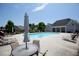 Relaxing community pool area with lounge chairs, tables, and a nearby clubhouse at 3209 Telhurst Way, Buford, GA 30519