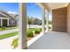 Covered porch with white columns overlooking a well-manicured lawn and neighborhood at 3209 Telhurst Way, Buford, GA 30519