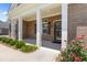 Charming brick home entrance with white columns, shutters and a welcoming doorway at 3209 Telhurst Way, Buford, GA 30519