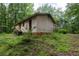 Exterior view of the house from backyard surrounded by lush greenery and trees at 400 Mccart Rd, Mcdonough, GA 30252