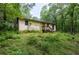 Exterior view of the house nestled among lush greenery and mature trees at 400 Mccart Rd, Mcdonough, GA 30252