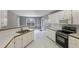 Eat-in kitchen with white cabinets, stainless steel appliances, and lots of natural light at 105 Hunters, Mcdonough, GA 30253