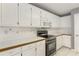 Bright kitchen with white cabinets, stainless steel appliances, and tile backsplash at 105 Hunters, Mcdonough, GA 30253