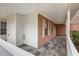 Inviting covered porch with stone tile flooring and white railing at 105 Hunters, Mcdonough, GA 30253