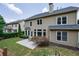 Backyard with patio and seating, framed by greenery and the home's exterior at 115 Dunlavin Dr, Acworth, GA 30102