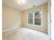Neutral bedroom with plush carpeting, a large window, and a view of the outdoor landscape at 115 Dunlavin Dr, Acworth, GA 30102