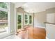 Bright breakfast nook featuring hardwood floors and lots of windows for natural lighting and backyard views at 115 Dunlavin Dr, Acworth, GA 30102