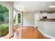 Charming breakfast area with hardwood floors, a view to the kitchen, and access to the outdoor living space at 115 Dunlavin Dr, Acworth, GA 30102