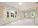 Open dining area with large windows offering backyard views and seamless transition to a cozy living space at 115 Dunlavin Dr, Acworth, GA 30102