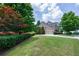 Serene view of a home featuring a lush, green lawn and driveway with an attached garage at 115 Dunlavin Dr, Acworth, GA 30102