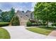 Charming home featuring an attached garage and long driveway with a lush lawn at 115 Dunlavin Dr, Acworth, GA 30102