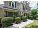 Tan home featuring meticulously trimmed bushes and a concrete walkway at 115 Dunlavin Dr, Acworth, GA 30102