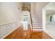 Inviting foyer with hardwood floors, a staircase, and wainscoting, creating an elegant entrance at 115 Dunlavin Dr, Acworth, GA 30102