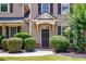 Inviting front entrance with a dark door and manicured shrubbery at 115 Dunlavin Dr, Acworth, GA 30102