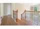 Hallway with hardwood flooring and wooden stair railings and spindles at 115 Dunlavin Dr, Acworth, GA 30102