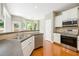 Bright kitchen with stainless steel appliances, countertops with breakfast bar, and adjacent dining space at 115 Dunlavin Dr, Acworth, GA 30102