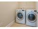 Well-lit laundry room featuring a modern washer and dryer set for convenient chores at 115 Dunlavin Dr, Acworth, GA 30102