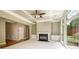 Elegant living room featuring a fireplace, coffered ceiling, and large windows for ample natural light at 115 Dunlavin Dr, Acworth, GA 30102