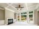 Comfortable living room with a fireplace, coffered ceilings, and large windows overlooking the backyard at 115 Dunlavin Dr, Acworth, GA 30102
