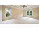 Spacious main bedroom with a tray ceiling, fan, carpeted floors and two windows providing natural light at 115 Dunlavin Dr, Acworth, GA 30102