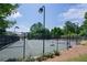 Outdoor tennis court surrounded by green foliage at 115 Dunlavin Dr, Acworth, GA 30102