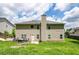 Back of the home with a lush green yard and a grill at 1849 Wanda Way, Ellenwood, GA 30294
