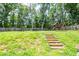 The property includes a backyard with playset, trampoline, basketball hoop, and plenty of grass at 1849 Wanda Way, Ellenwood, GA 30294
