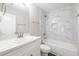 This bathroom features a tub and shower with white marble tile and white cabinets at 1849 Wanda Way, Ellenwood, GA 30294