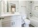 Bathroom featuring white marble tile, modern fixtures, and a shower tub combination at 1849 Wanda Way, Ellenwood, GA 30294