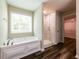 Elegant bathroom features large soaking tub, separate glass-enclosed shower, and natural light at 1849 Wanda Way, Ellenwood, GA 30294